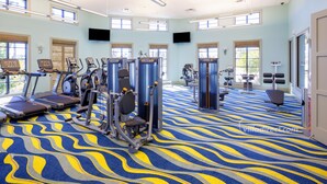 A gym with treadmills, elliptical machines, and weight stations. - Moon Valley by VillaDirect (Davenport)