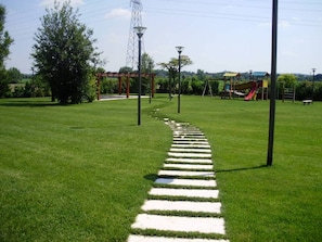 Stroll along the well-maintained pathway to a family-friendly playground area.