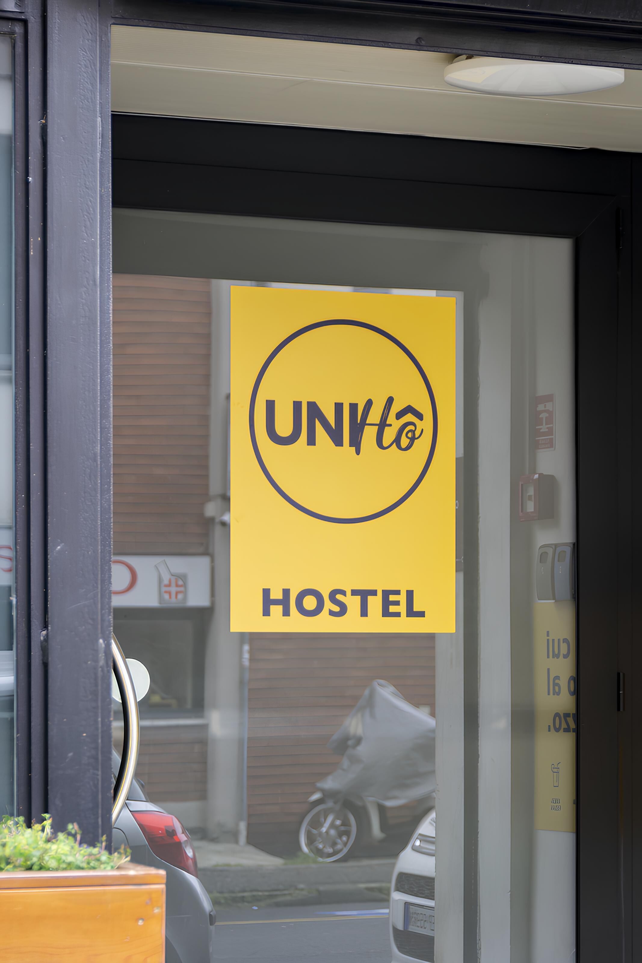 A hostel sign with the name "UNHto" and the word "HOSTEL" below it.