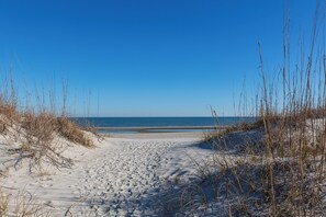 A sandy beach with a clear blue sky and ocean in the background. - Captains Walk Fifth Floor - Closest Direct Ocean Front, Captains Walk - closet direct oceanfront (Hilton Head Island)
