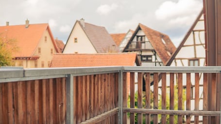 A wooden fence with a view of traditional European houses with sloped roofs.. Hotel Restaurant Zum Nachtwächter