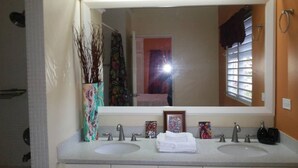 A bathroom with two sinks, a large mirror, and a window with blinds. - Artscape Jamaica Villa @Richmond near Ocho Rios (Priory)