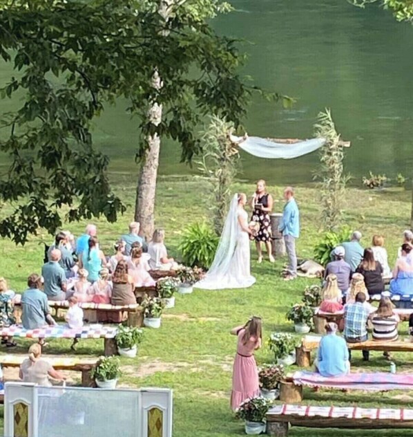Couples can exchange vows surrounded by lush greenery and serene water views.