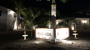 A sign for 'PURA VIDA' with a palm tree in the background.