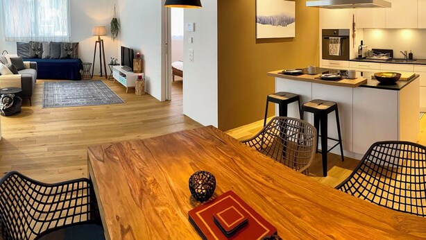 A modern apartment with a dining area, kitchen, and living space. - SnowKaya Appartement/Fewo 5-Bettwohnung by Interhome (Engelberg)