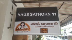 A sign for Haus Sathorn 11 with a 'Grab & Go' service. - Haus Sathorn 11 Bed & Breakfast (Bangkok)