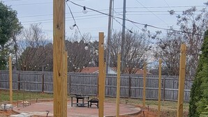 A paved pathway with wooden posts, a wooden fence, and a bench in a landscaped area. - Beautiful Rustic Murfreesboro Home just minutes from I24, MTSU and more (Murfreesboro)