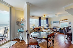 Relax in a spacious living area with a high ceiling and stunning views of the surrounding landscape.