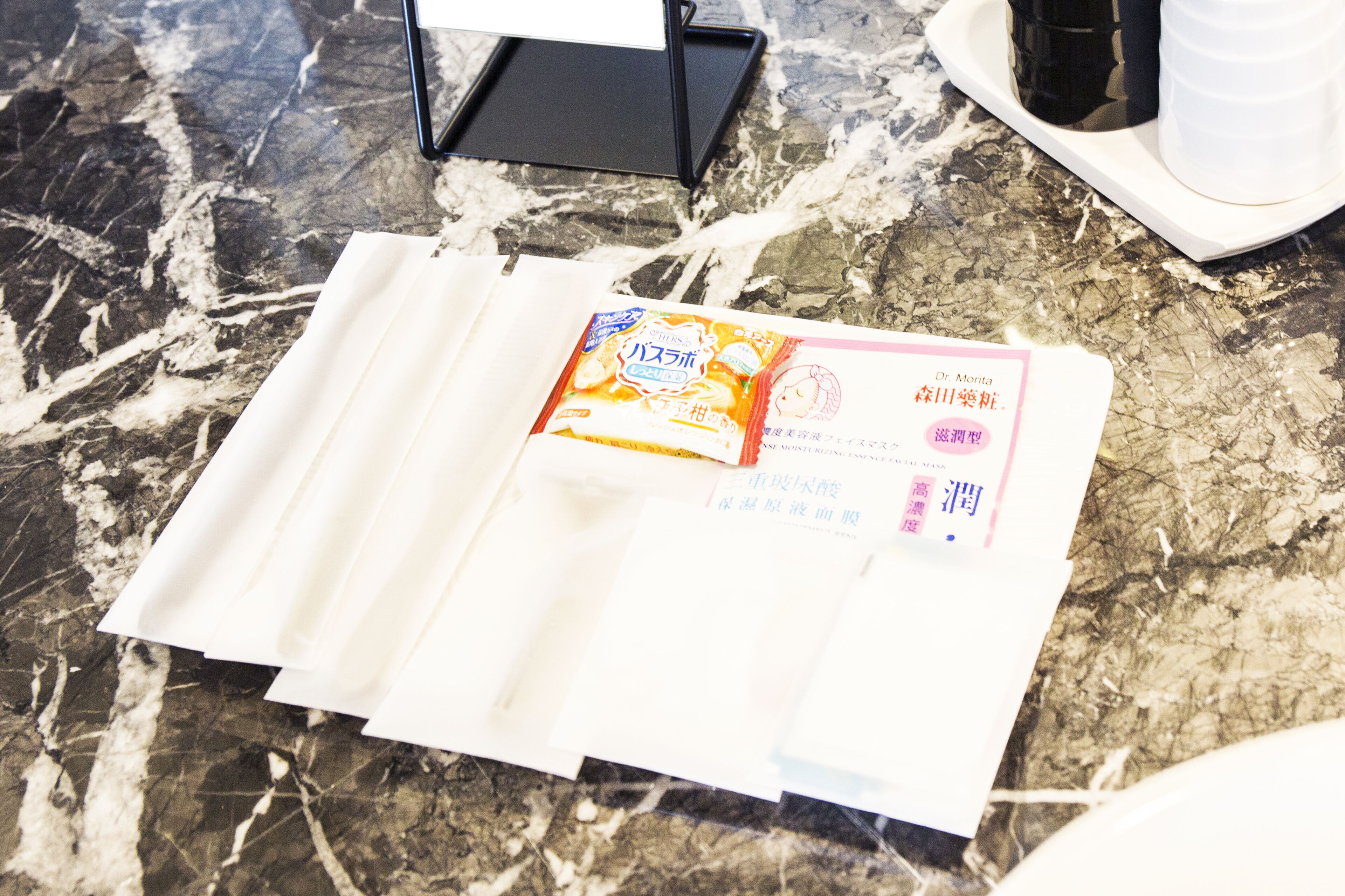 A package on a marble surface with a receipt and a black box in the background.