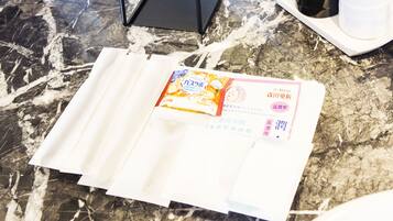 A package on a marble surface with a receipt and a black box in the background.