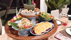 A dining table with various dishes, including a salad, a bowl of beans, and a dessert. - Nine Hotel Chiangmai (Chiang Mai)
