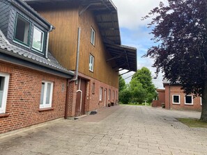 A building with a brick facade and a wooden upper section.