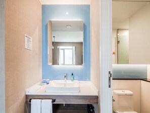 A bathroom with a sink, mirror, and toilet. - Holiday Inn Express Litang by IHG (Garze)