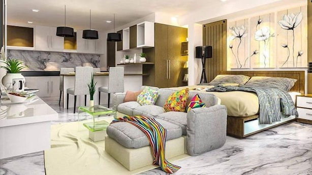Una sala moderna con sofá, reposapiés y un comedor con sillas y una mesa.