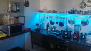 A kitchen with a countertop, microwave, coffee maker, and various kitchen utensils and appliances. - Penthouse with pool, barbecue, and bathtub: Jeanne's Country House (Rio de Janeiro)