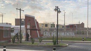Entrada de un hotel con un camino empedrado y portón, un letrero que dice "SOL DE PIMENTEL", y una calle con acera y césped en primer plano.