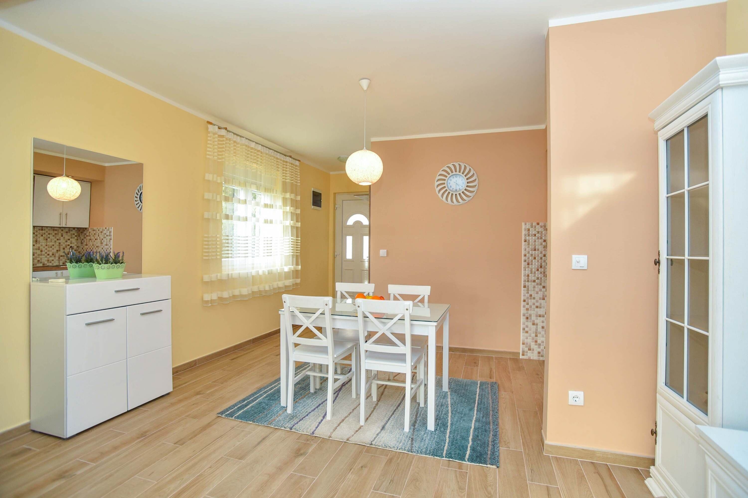 A compact living space with a kitchen, dining area, and a small bathroom.
