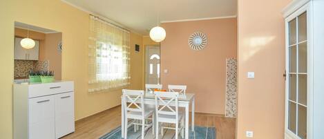 A compact living space with a kitchen, dining area, and a small bathroom.