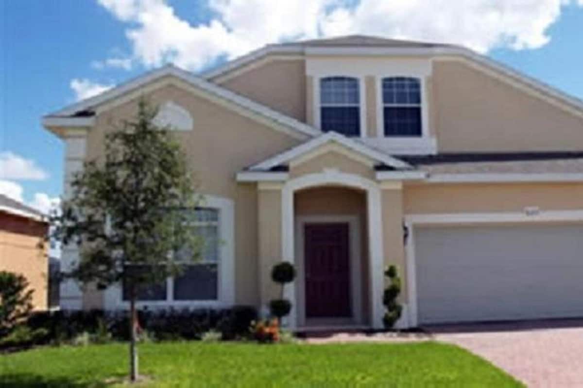 A single-story house with a garage, a front door, and a small front yard.