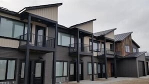 A modern multi-story residential building with balconies, large windows, and a flat roof. - Awesome new unit available!  Walking distance to great Amherst places and events (Amherst)