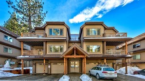 A multi-story residential building with a central entrance, balconies, and a garage. - Tahoe Woods #602 Walk to Gondola, Lake, Casinos (South Lake Tahoe)