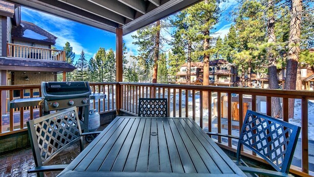 A covered outdoor deck with a grill, seating, and a view of a forested area. - Tahoe Woods #602 Walk to Gondola, Lake, Casinos (South Lake Tahoe)