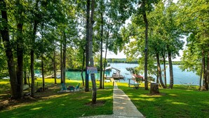 A lakeside park with a no lifeguard warning sign, picnic tables, and a hammock. - 2-Bedroom, Dog Friendly Home sleeps 6 on the Tennessee River/Chickamauga Lake (Decatur)