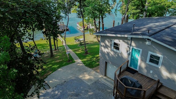 A house with a deck, a blue door, and a view of a lake. - 2-Bedroom, Dog Friendly Home sleeps 6 on the Tennessee River/Chickamauga Lake (Decatur)