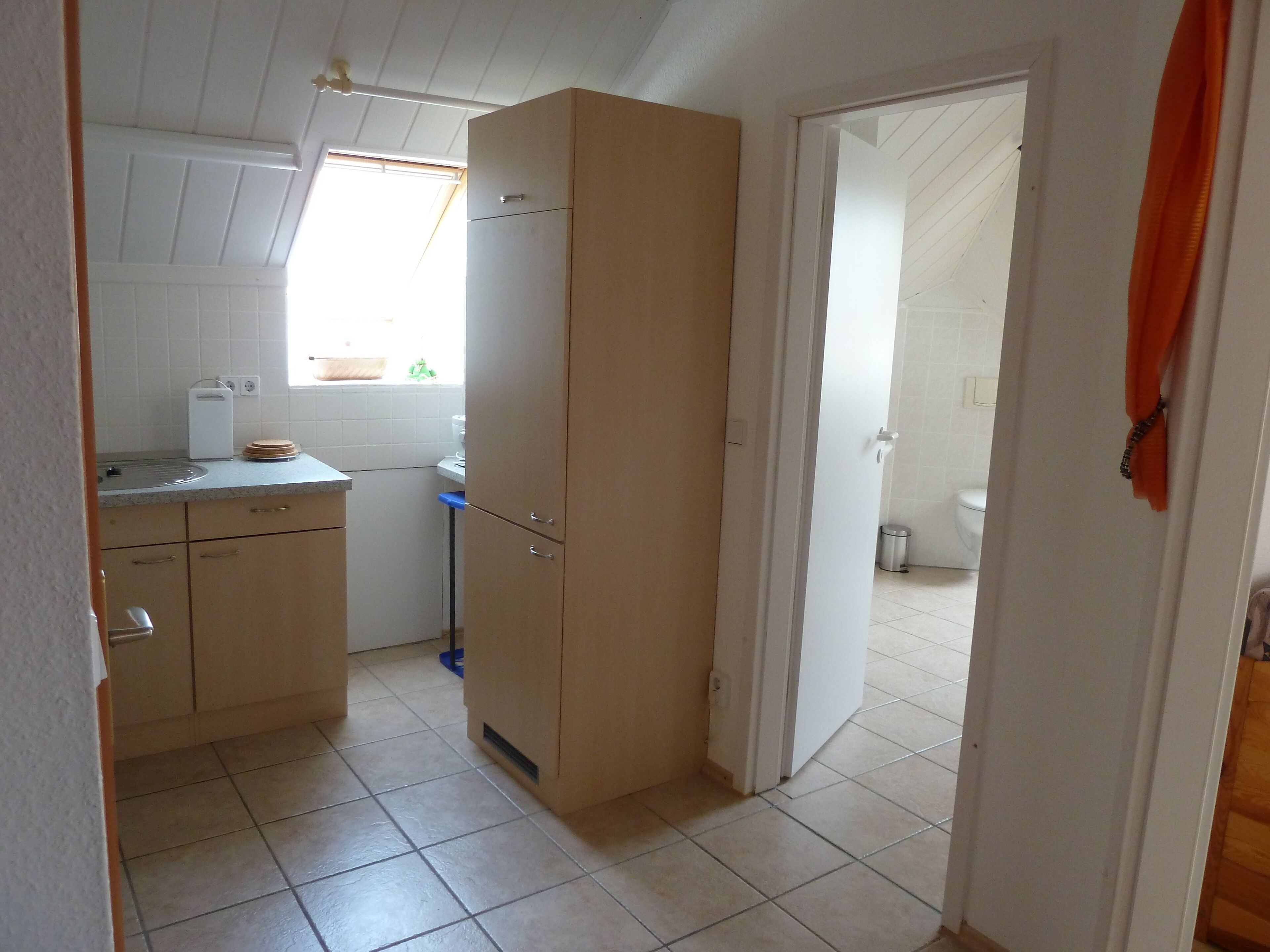 A compact kitchen with a window, a sink, and a countertop.