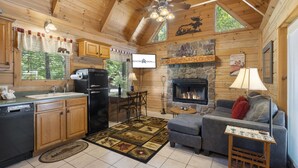 A cozy cabin interior with a kitchen, dining area, and living room.