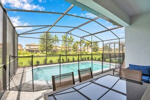 Relax by the pool surrounded by lush greenery and a clear view of the surrounding landscape.