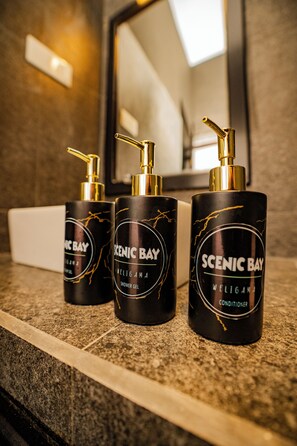 Three bottles of Scenic Bay shower gel and conditioner on a granite countertop. - Scenic Bay Weligama (Weligama)