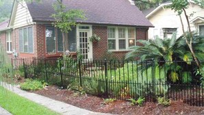 A two-story house with a brick exterior, a dark roof, and a black metal fence. - Downtown Historic district at Cascades Park, Best location (Tallahassee)