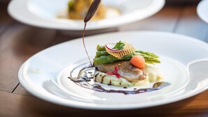 A plate of food with a sauce being poured over it. - Seasalter Maldives (Hulhumalé)