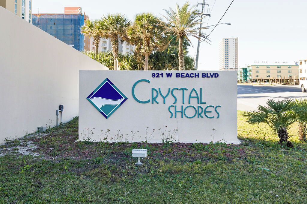 A sign for Crystal Shores at 921 W Beach Blvd.