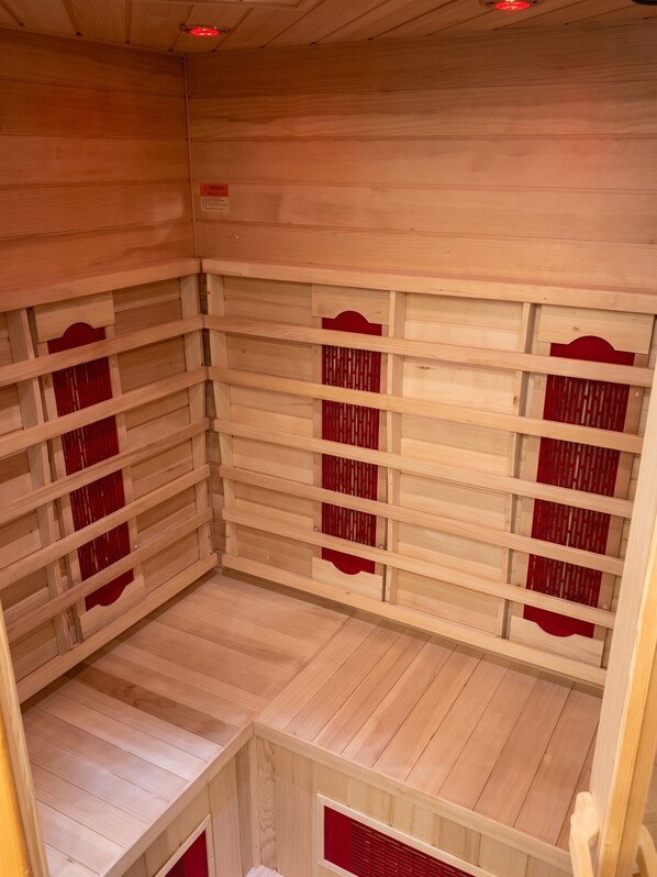 A sauna room with wooden walls and benches.