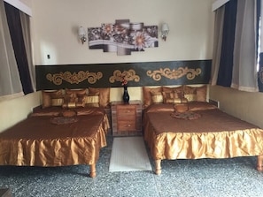 A double bed room with a headboard, a bedside table, and a decorative wall piece. - Hostal Bola 8 (Remedios)
