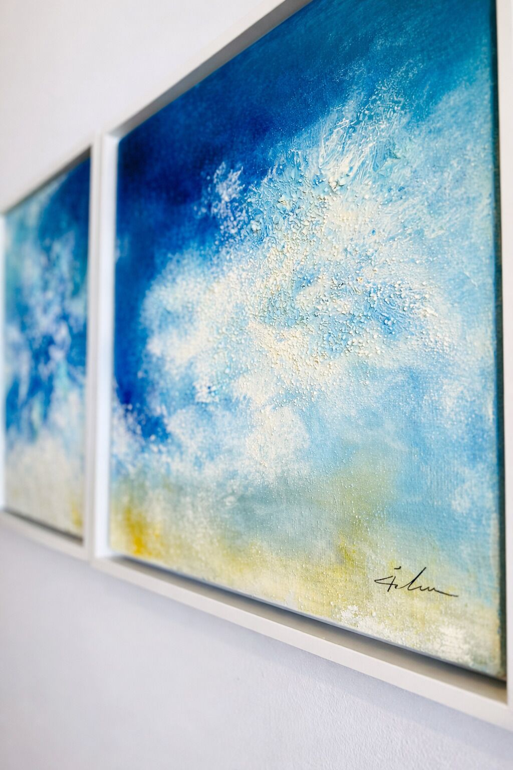 A wall with three framed artworks.