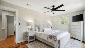A bedroom with a bed, nightstands, a dresser, a ceiling fan, and a TV. - Coastal Classic Blue Mountain Beach Condo! (Santa Rosa Beach)