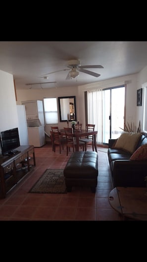 Cozy living space with a dining area, sofa, and TV.