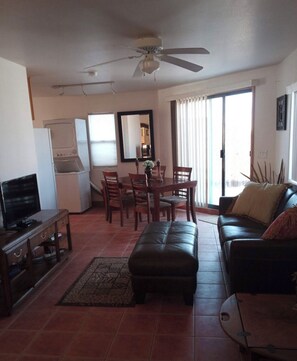 Cozy living space with a dining area, sofa, and TV.