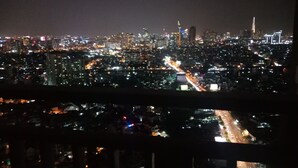 Un paisaje urbano nocturno con densos conjuntos de edificios y calles iluminadas.