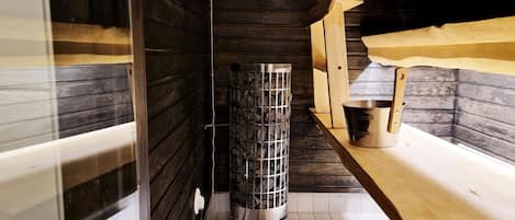 Relax in a serene sauna with a heater and bench for ultimate relaxation.