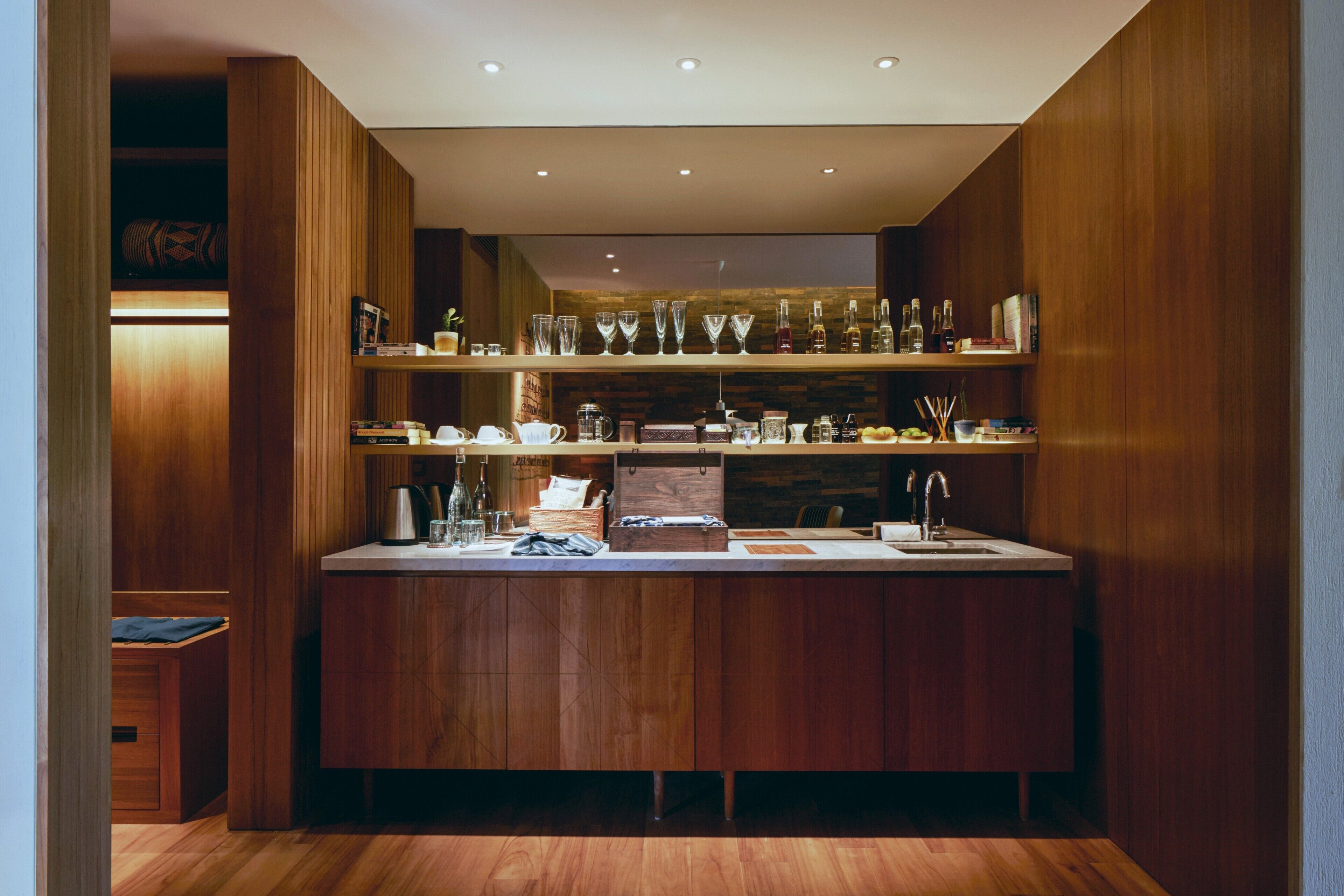 A modern kitchen with wooden cabinetry, a countertop, and various kitchen appliances.
