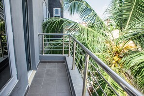 A staircase with metal railings, surrounded by lush green palm trees. - Etor Residence Hotel (Lekki)