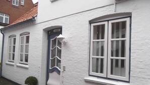 A white building with a blue door and windows. - Carl-Häberlin-Str. 15, EG (Wyk auf Föhr)
