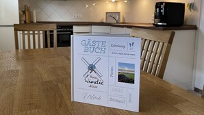 A wooden table with a menu in a modern kitchen. - North Sea vacation with children (Dornum)