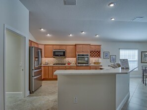 Fridge, microwave, oven, stovetop - Designer Luxury: 3BR/2BA Oasis with Pool, Golf Cart, and More! (The Villages)