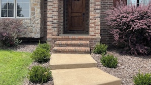 A brick house with a front porch, a wooden door, and a wreath. - Golf Getaway-Perfect for Large Families! Book Now For Christmas!  (Springfield)
