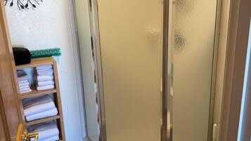 Shower, hair dryer, towels, shampoo
